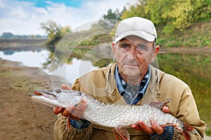 Old fisherman and his catch - pike