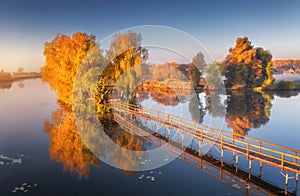 Old fisherman house and wooden pier at sunrise in autumn