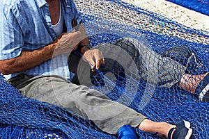 Old Fisherman Mending Nets