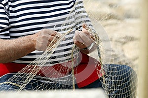 Old fisherman Mending Nets