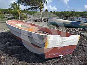 Old fishermen boats stranded on the Caribbean coast in a natural tropical environment. Old wrecked boat, stranded on the beach