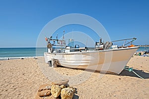 Old fishers boat on the beach in Armacao de Pera in the Algarve Portugal