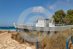 Old fishing boat on Ammos Kambouri beach. Ayia Napa, Cyprus