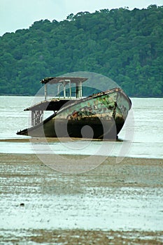 Old fishing boat collapsed in the sea.