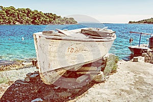 Old fishing boat with cracked white paint, Solta, yellow filter