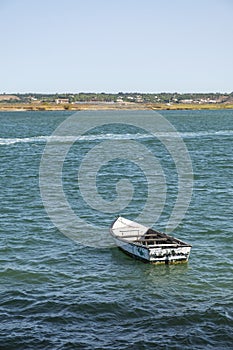 An old fishing boat moored near the beach