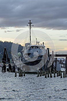 Old Fishing Boat Moored On A Pier In A Small River