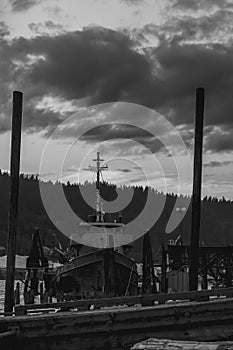 Old Fishing Boat Moored On A Pier In A Small River