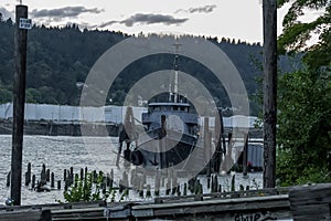 Old Fishing Boat Moored On A Pier In A Small River