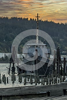 Old Fishing Boat Moored On A Pier In A Small River