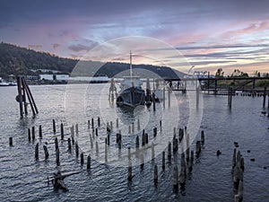 Old Fishing Boat Moored On A Pier In A Small River