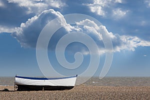 Old fishing boat on pebble beach