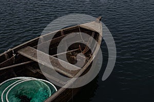 Old fishing boat with a rusty anchor and fishing nets