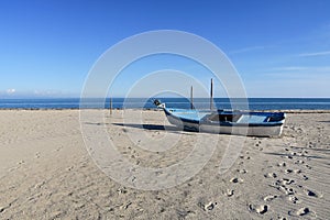 Old fishing boat on sandy beach