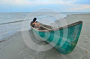Old fishing boat on sea beach