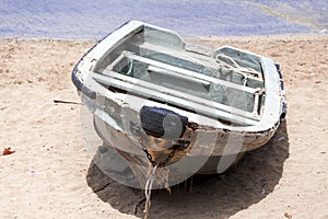 Old fishing boat on the shore. Boat with nets waiting for fishermen on the beach of Cape Verde