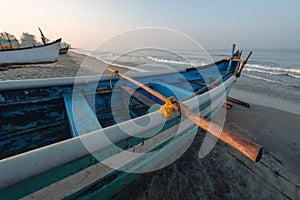 Old fishing boats on beach in Goa, India.