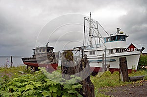 Old fishing boats sitting on shore in Alaska,