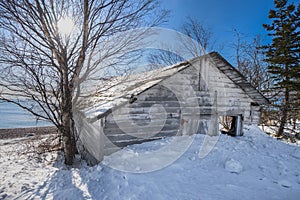 Old Fishing Shack Along Shore of Lake Superior Winter Into the Sun