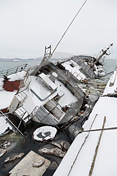 Old fishing ship sank at pier in port