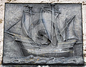 Old, flat sculpture of a ship,