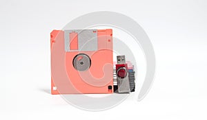 Old floppy disk and flash drive put on white background.