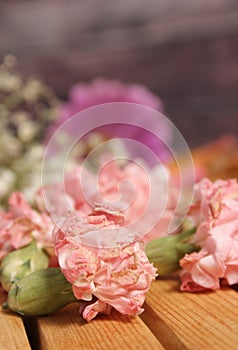 Old Flowers Drying on Wooden Table. Zinnias With Roses and Carnations