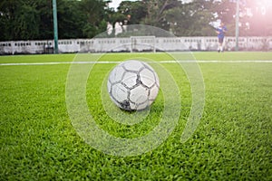 Old football on Artificial turf football field green