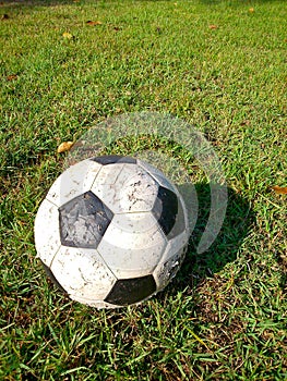 Old football on grass field