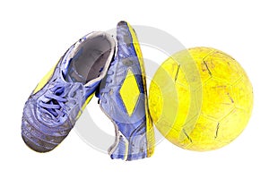 Old football shoes damaged and old dirty yellow futsal ball on white background football object isolated