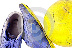 Old football shoes damaged and old dirty yellow futsal ball on white background football object isolated