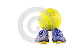 Old football shoes damaged and old dirty yellow futsal ball on white background football object isolated