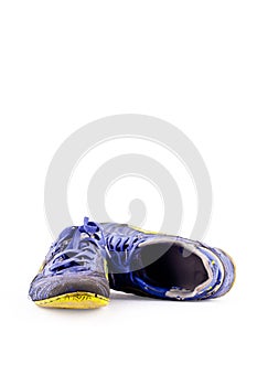 Old football shoes damaged on white background futsal sportware object isolated