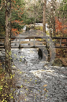 Old footbridge over a stream in small upstate New York town