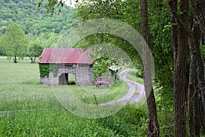 Old Ford Rusted Truck with a barn and curvy road