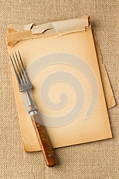 Old fork and yellowed notebook