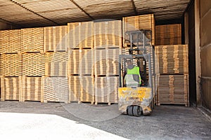 The old forklift load lumber into dry warehouse