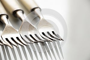 Old forks on a white background close-up, kitchen utensils, cutlery