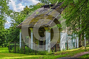 Vintage forlorn house deep in city park with lush green foliage photo