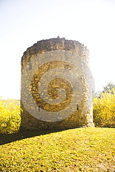 An old fortified tower on a hill in the sun at autumn