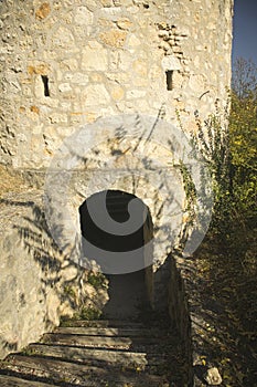 An old fortified tower on a hill in the sun at autumn