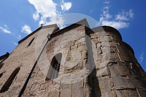 Old fortress against the blue sky with clouds