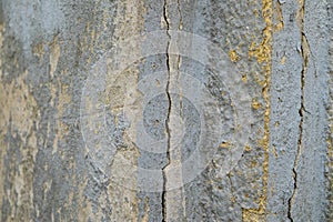 Old foundation and plaster wall with cracks. Building requiring repair closeup