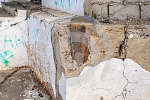 Old foundation wall with cracks and chips