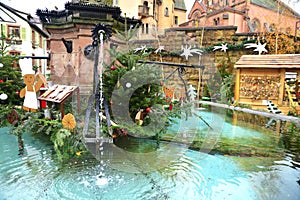 Old fountain decorated for Christmas in Eguisheim, Alsace, France