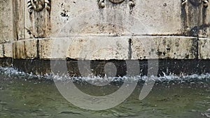 Old fountain in Matera with the water falling down and the drops bounce, historical monument and