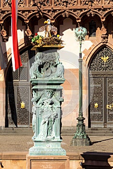 Old fountain at roemer with an artifical stoch nest and allegory photo