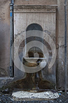 Old fountain in the roman city, near to panteon of Roma photo