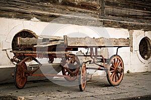 An old four-wheeled horse-drawn carriage stays abandoned. old cart carriage or horse wagon without the horse.