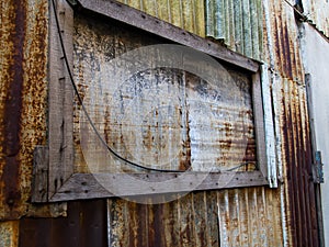 Old frame wood with Rusty Corrugated metal texture or Galvanized iron steel background